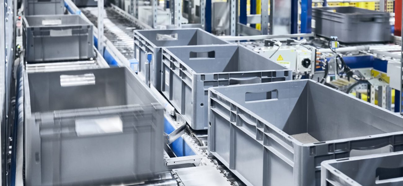 Conveyor system with boxes in motion, shallow depth of field.